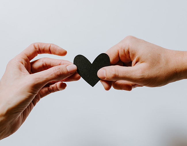 Hands holding a paper heart